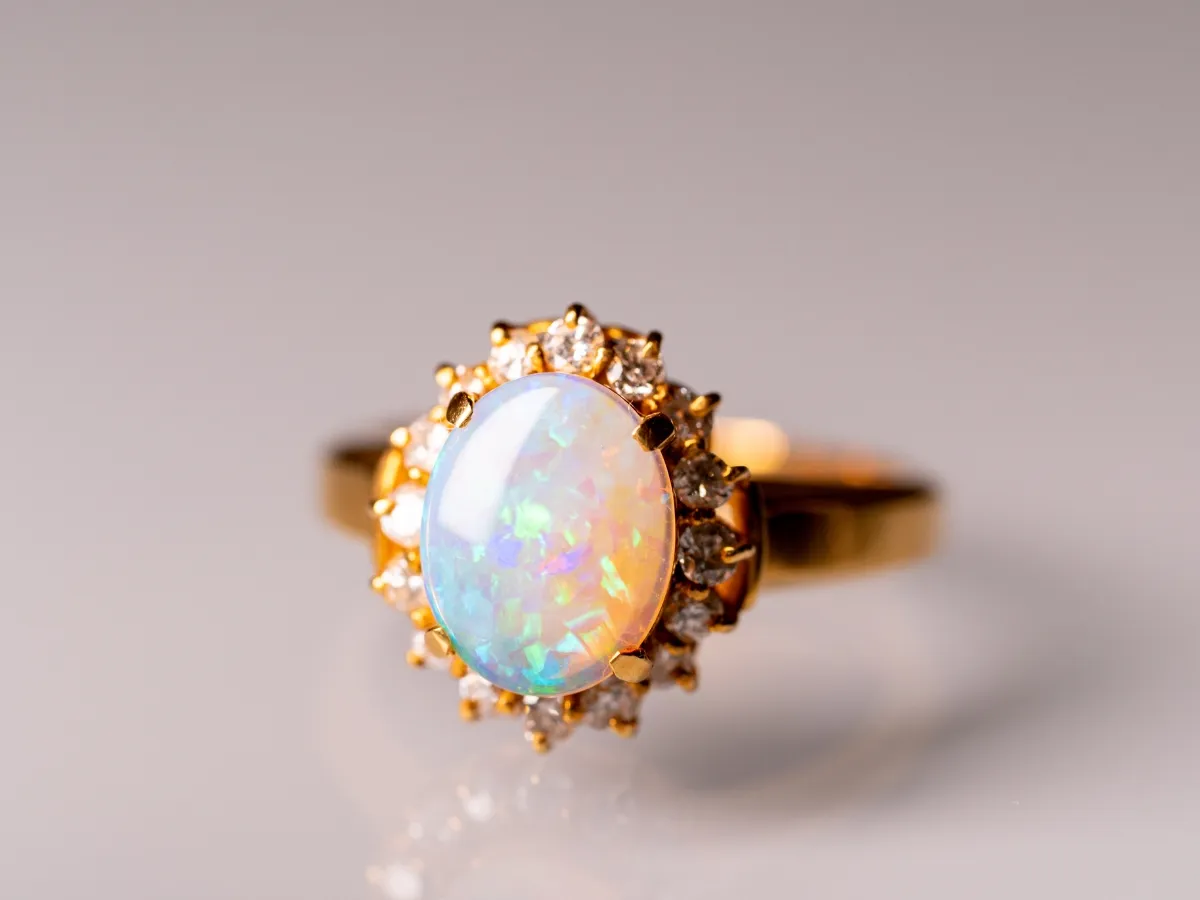Opal ring with diamond halo setting.