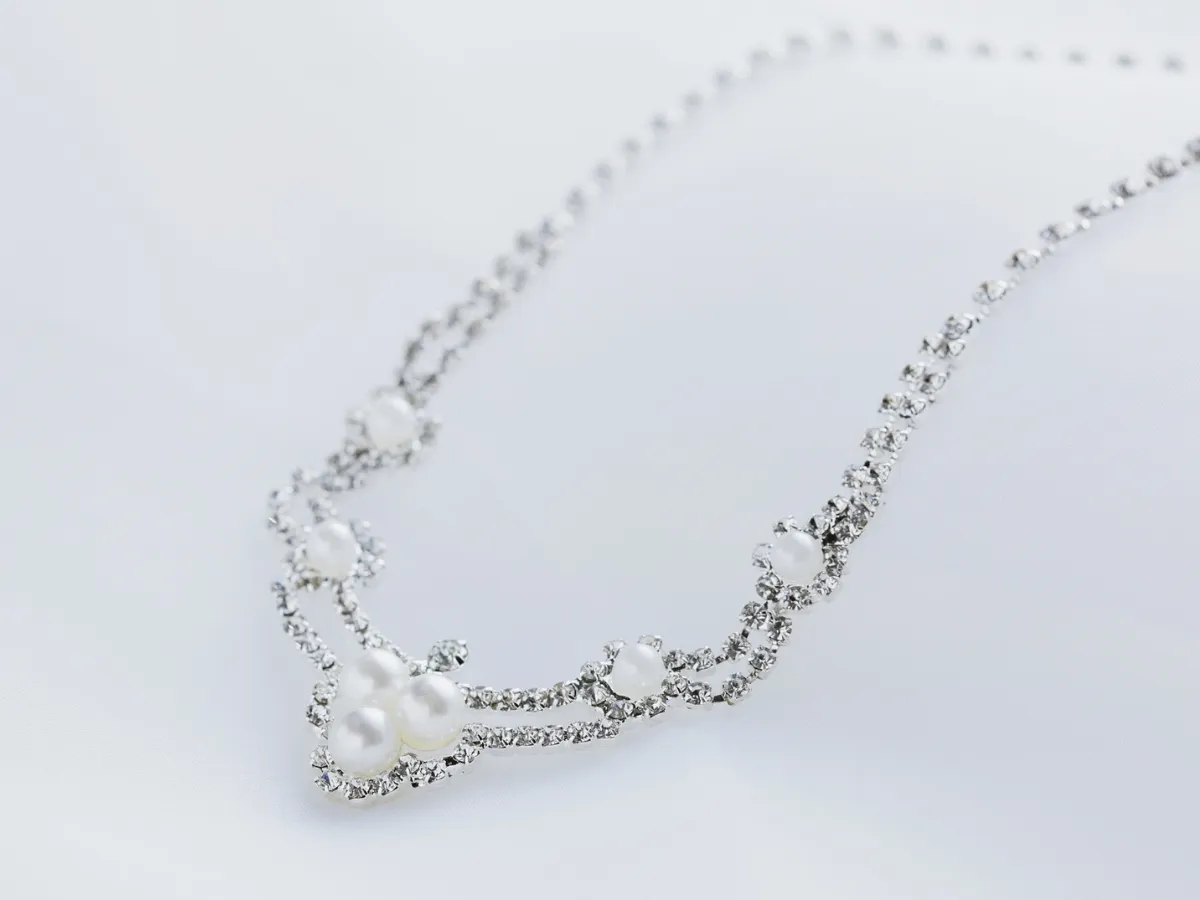 Silver necklace with pearls and rhinestones.