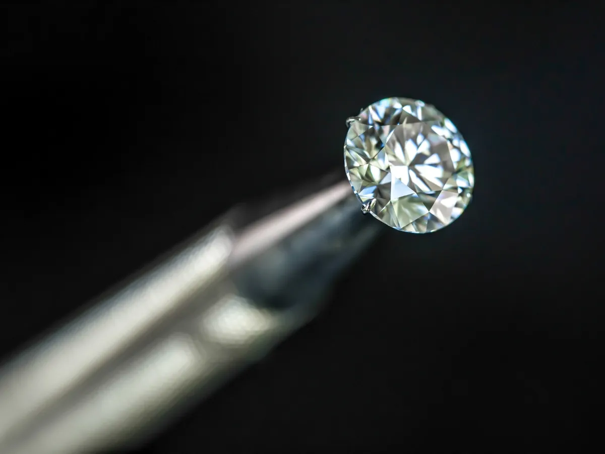 Diamond held in tweezers macro view