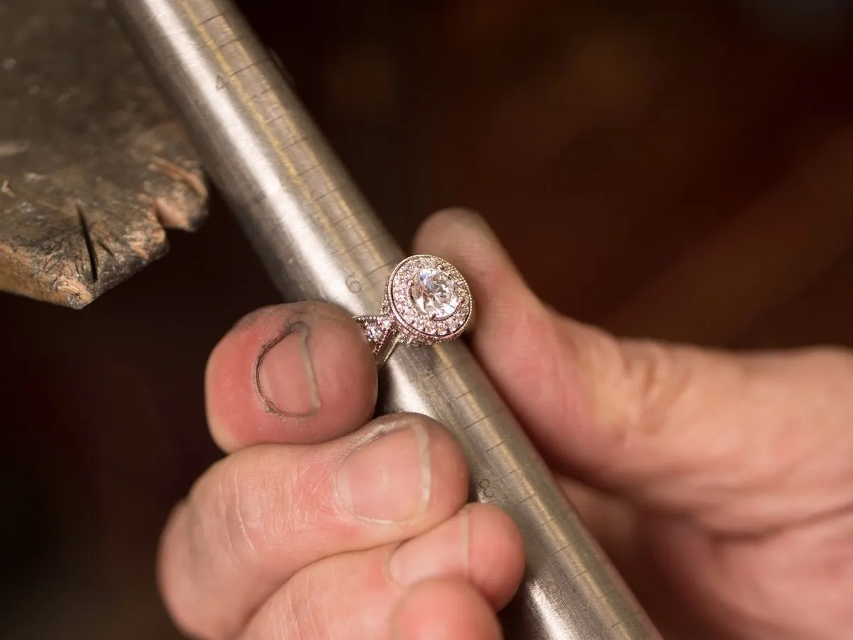 Jeweler sizing diamond engagement ring.