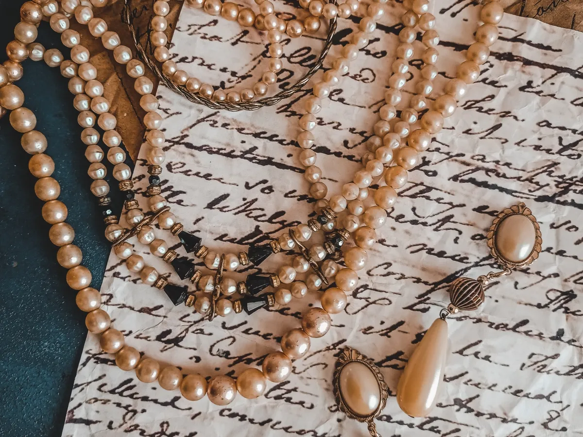 Vintage pearl jewelry on handwritten letter.