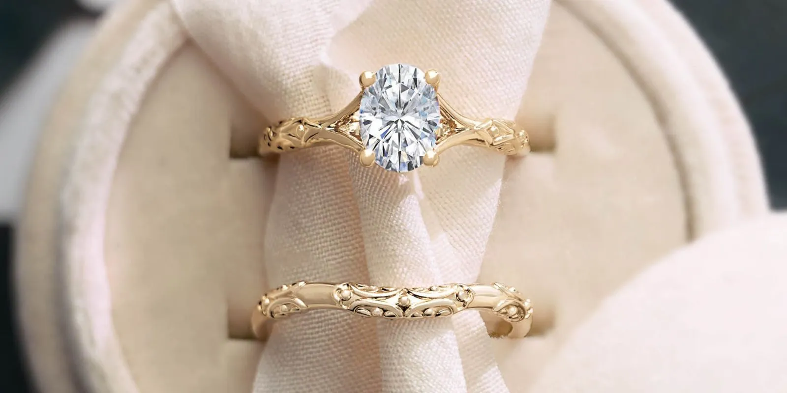 The image shows a set of three elegant diamond rings. The centerpiece is a solitaire engagement ring, surrounded by two matching