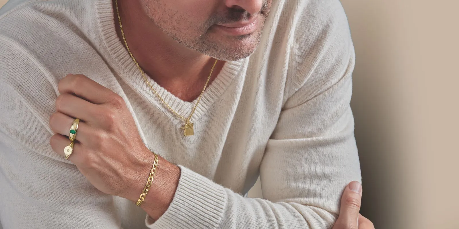 The image features a gold-tone wristwatch with a sleek design, showcasing a white dial with a crystal-encrusted bezel and a clas