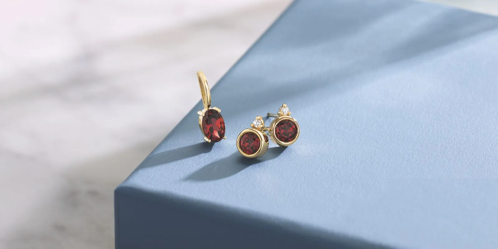 The image shows a pair of pearl stud earrings and a bracelet with a woven design and pearl-like embellishments. The jewelry is e