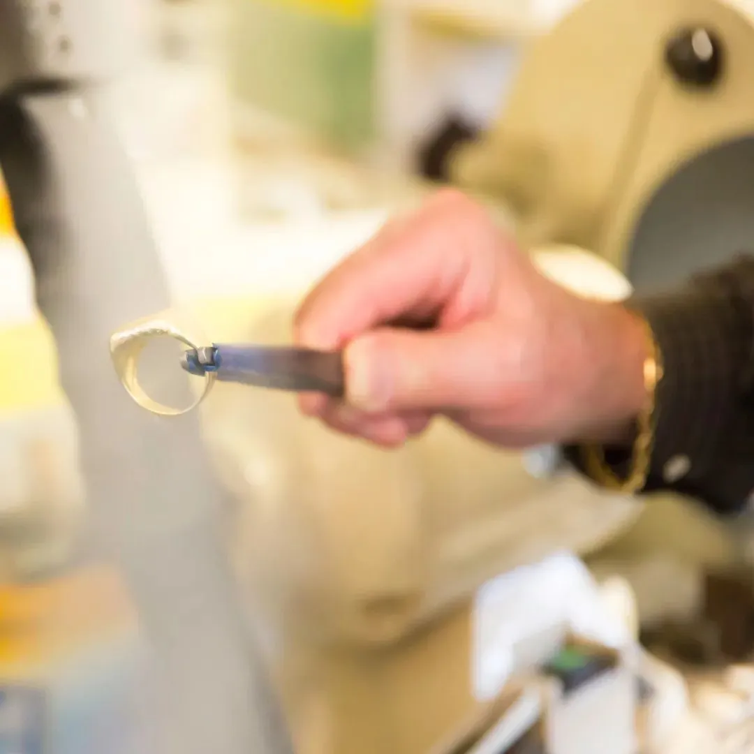 A jeweller cleaning a ring at Vandenbergs Fine Jewellery in Winnipeg.