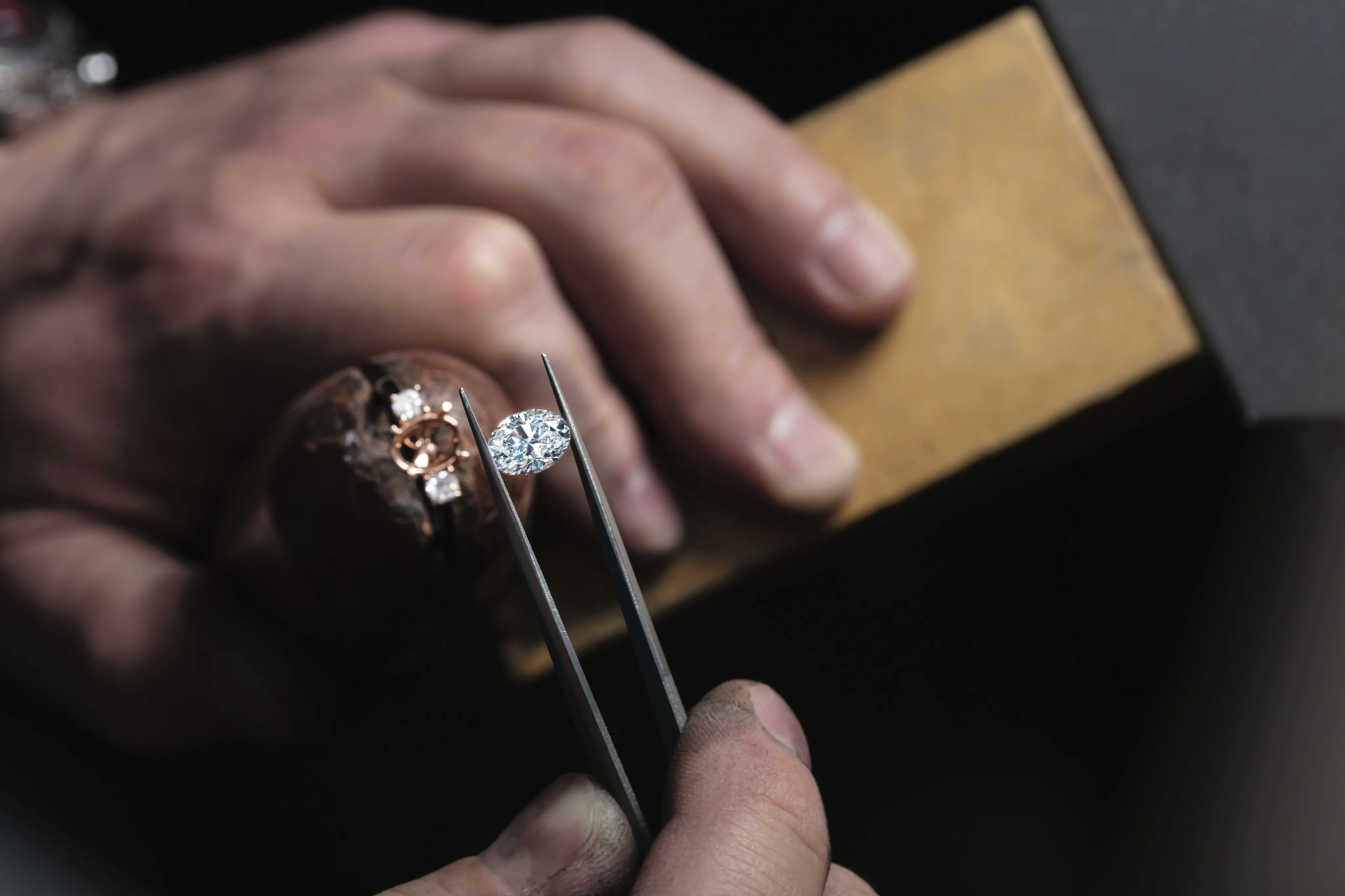 Woman with long nails wearing rings and a bracelet by the beach