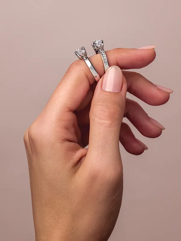 Woman wearing two engagement rings on index finger