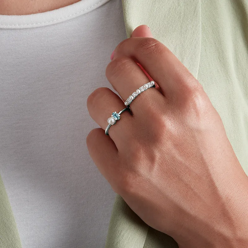 Woman wearing pearl fashion rings