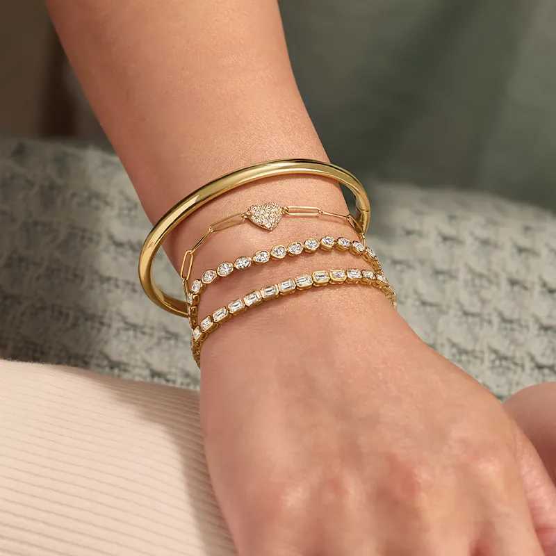 Woman wearing gold and diamond bracelets