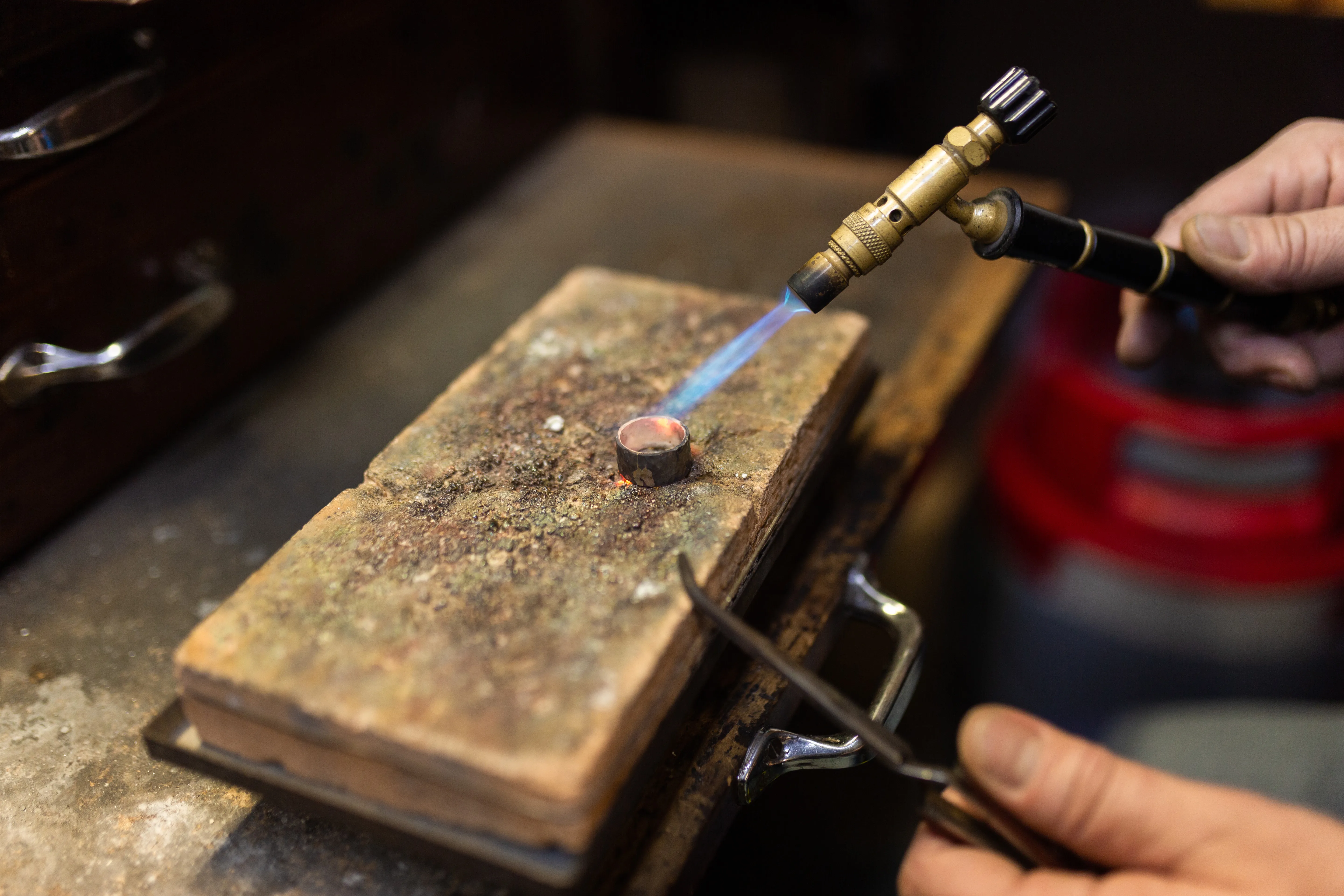 Multiple dainty necklaces laying on top of one another in various metal types such as gold, silver, and rose gold