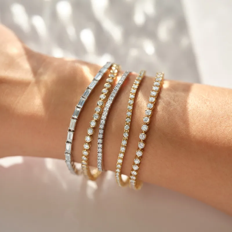 Woman wearing various gold and silver diamond bracelets on wrist