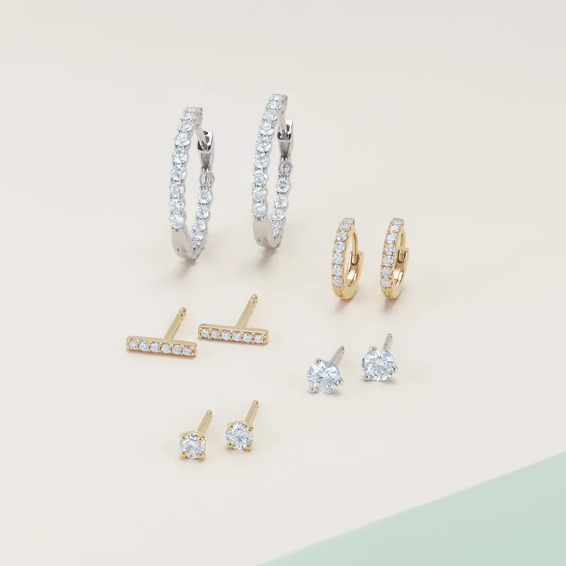 Various diamond earring styles including studs, huggies, and hoops on tan and green background