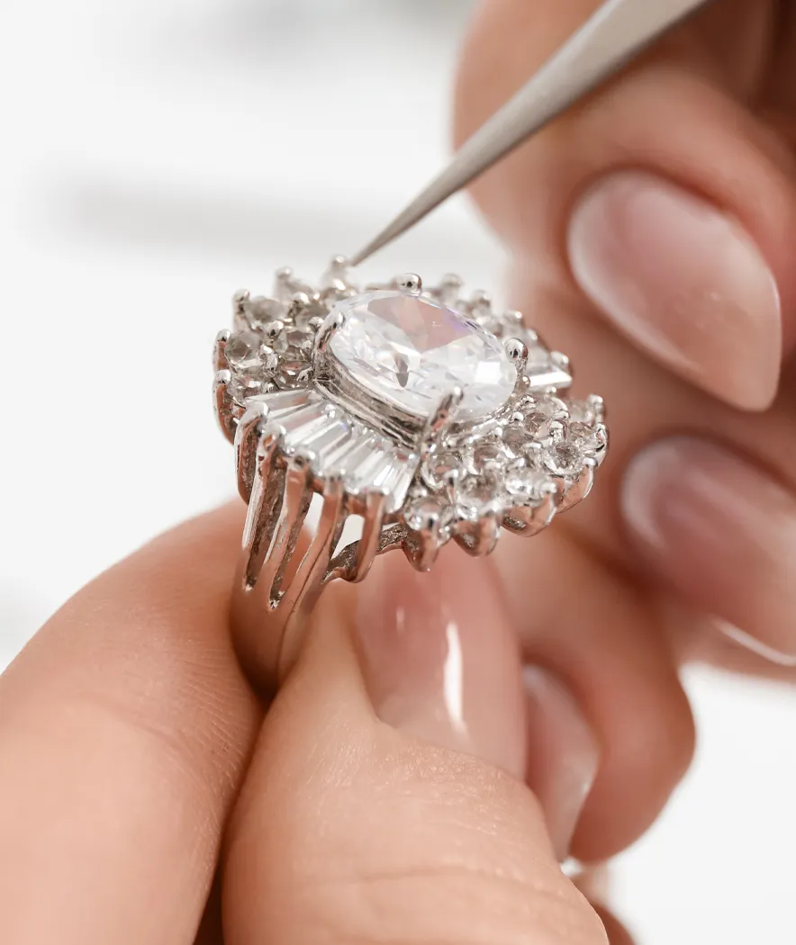 Woman repairing the stones of a large diamond ring