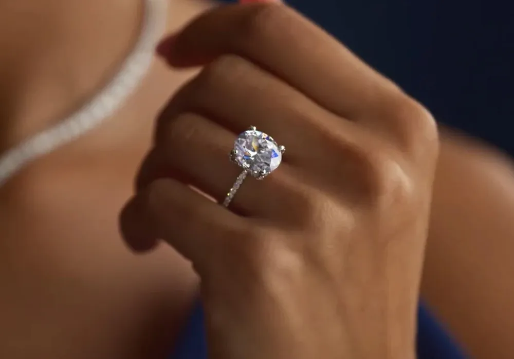 Person wearing large round diamond engagement ring