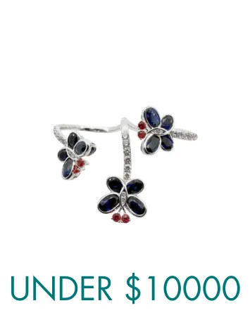 Close-up of a woman wearing a sparkling hoop earring. Click to shop all earrings at Ware's Jewelers.