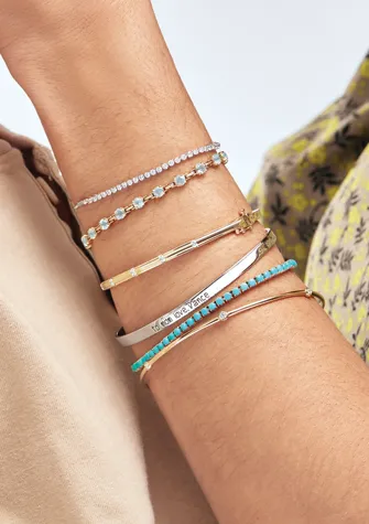 Stacked gold and diamond bracelets