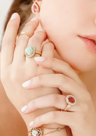Gemstone and gold rings on a hand
