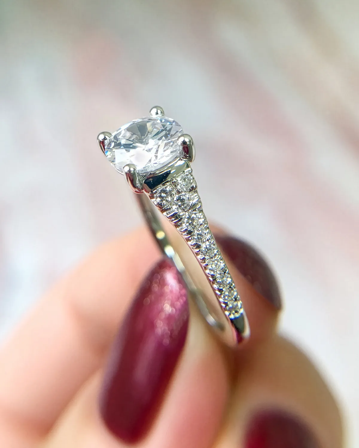 Elegant diamond engagement ring with a large center stone and smaller side stones.