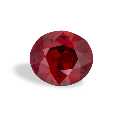 An oval, faceted red ruby gemstone on a white background.
