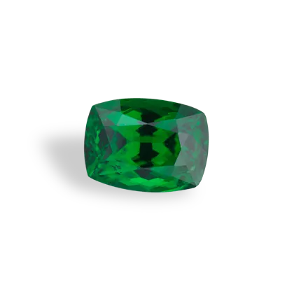 A vibrant green tsavorite garnet gemstone on a white background.