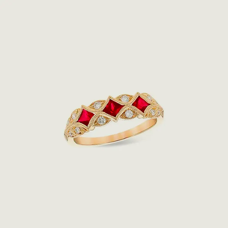 Elegant gold ring featuring red stones and diamonds, perfect for special occasions.