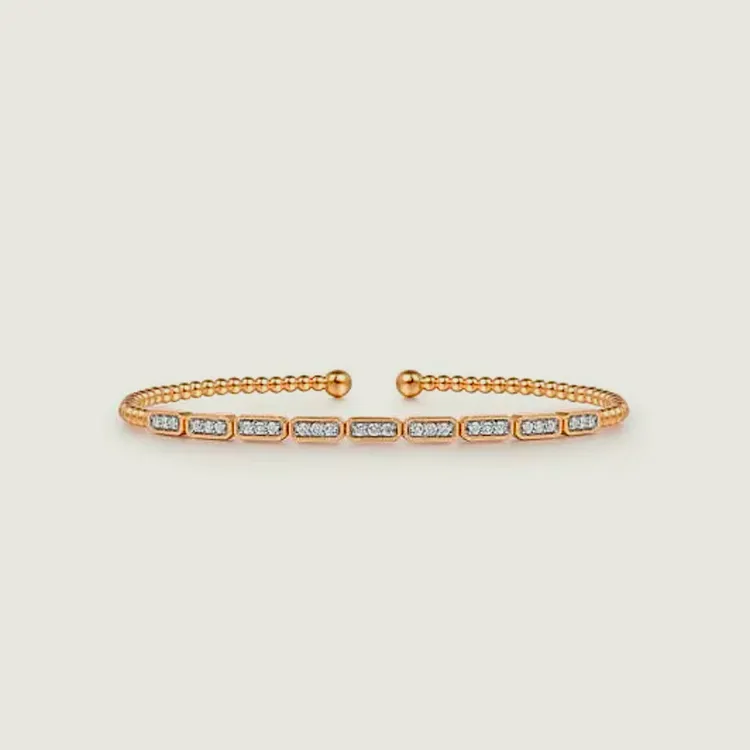 Gold cuff bracelet with diamond accents, perfect for elegant jewelry styling.
