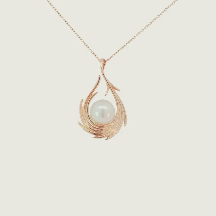 Elegant rose gold pendant with a pearl, designed in a swirling leaf pattern.
