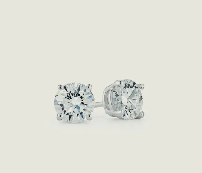 Sparkling diamond stud earrings displayed on a light background.