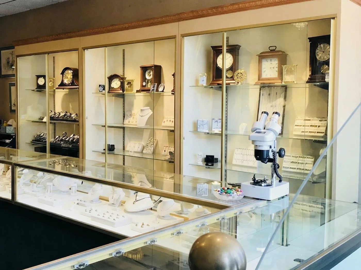 Jewelry store interior with display cases of clocks, watches, and jewelry.