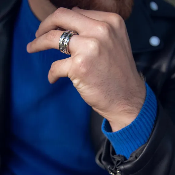 Man wearing cobalt blue sweater and leather jacket wearing tungsten and black diamond wedding band