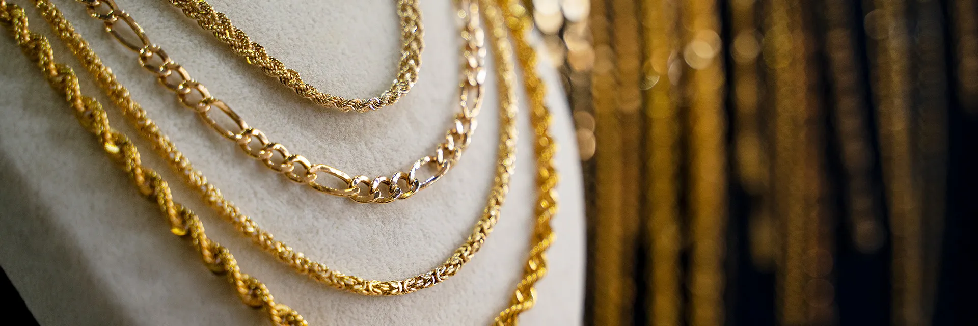 Collage of gold jewelry including necklaces, earrings, and bracelets from Sif Jakobs' collection at Arezzo Jewelers. Shop Now.