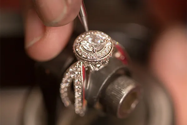 A jeweler repairing a diamond ring