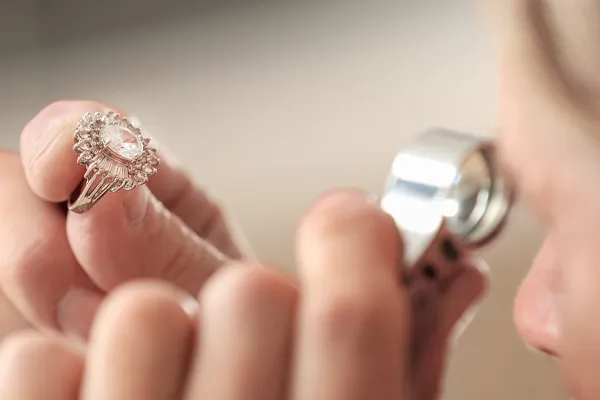 A ring examined under a loupe for an appraisal