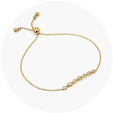 Gold bracelet with sparkling stones, adjustable clasp. Click to explore more bracelets at Mesa Jewelers.
