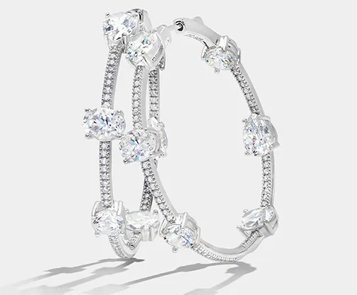 Elegant silver hoop earrings adorned with sparkling diamonds. Click to learn more about Mesa Jewelers in Grand Junction.