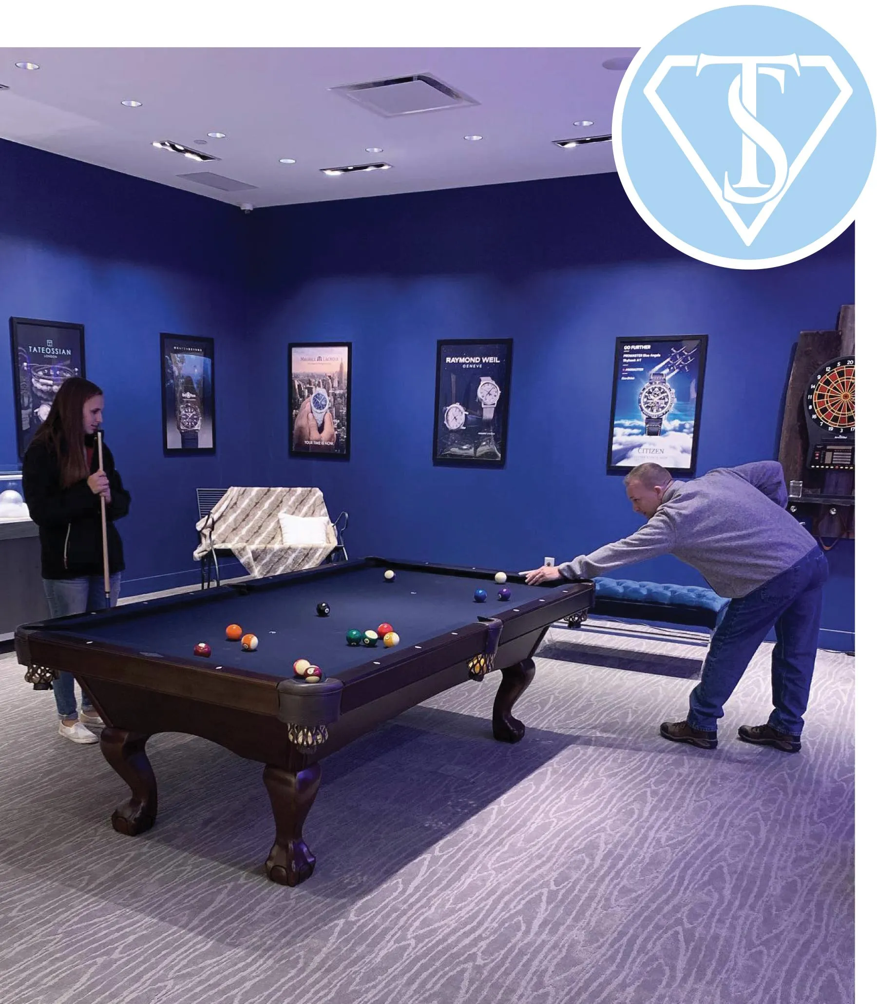Two customers playing pool in the back lounge area of The Source Fine Jewelers in Eastview Mall